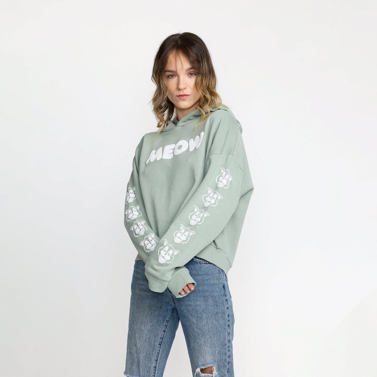 Ted & Herb Meow Crop Pullover in sage front print on model; official Ted & Herb merch by TSURT