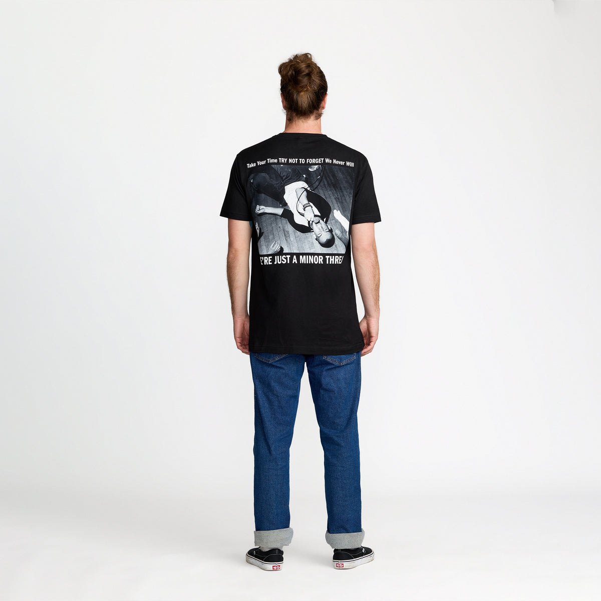 Person wearing a black Minor Threat Just A Tee, standing against a white background; official merch by TSURT