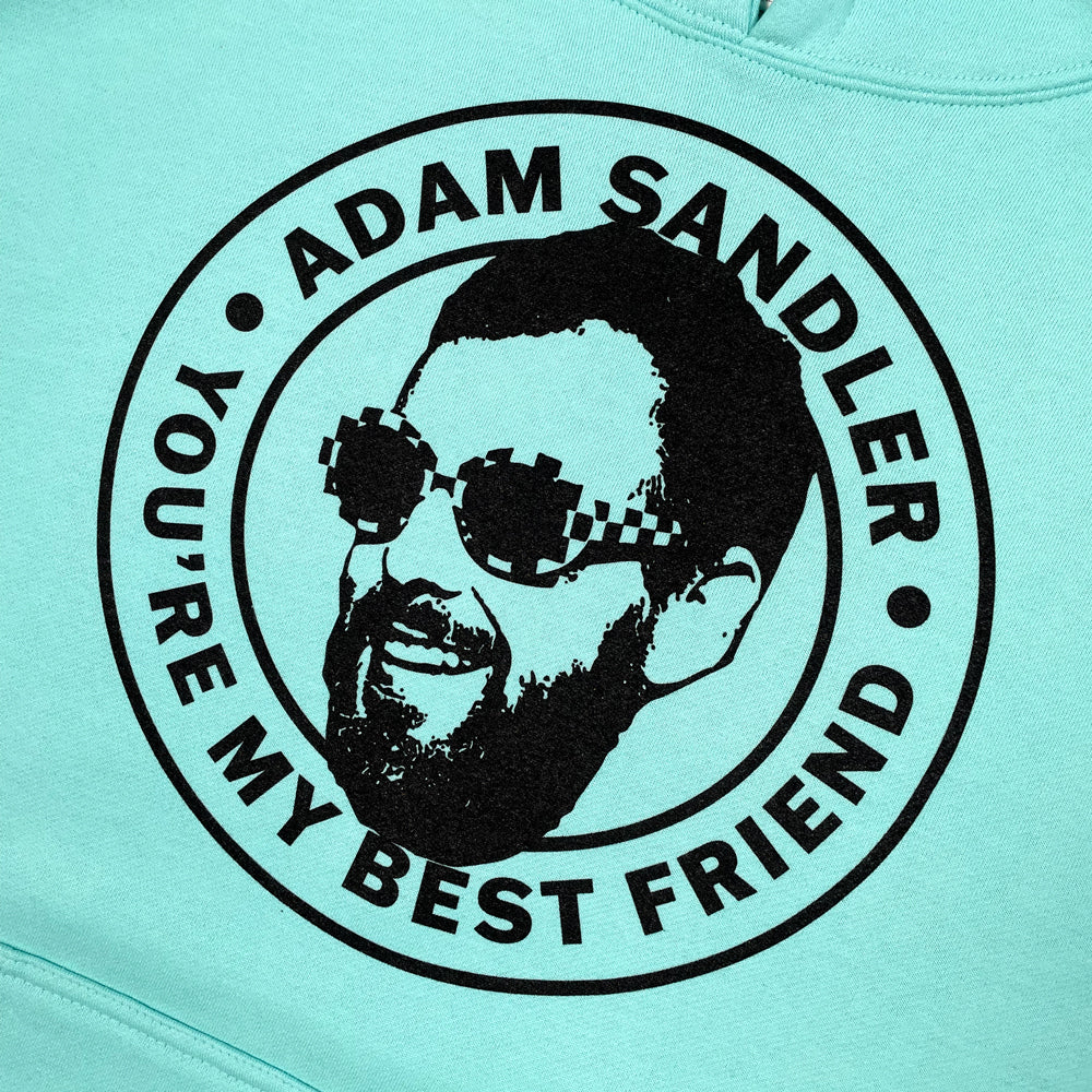 Close up of a mint colored hoodie with graphic of Adam Sandler and text reading "Adam Sandler You're My Best Friend" 