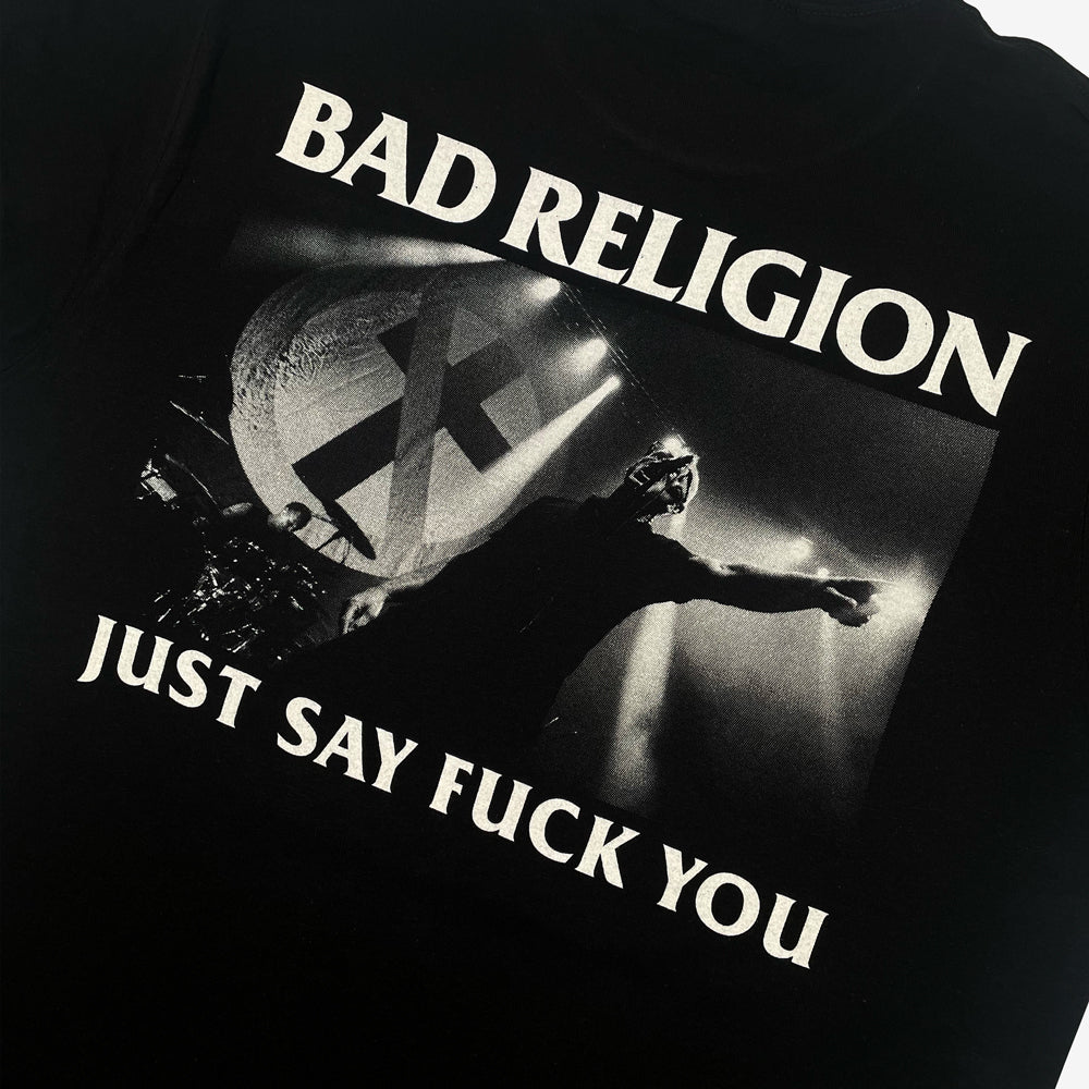 Close up of a black Bad Religion Tee featuring image of band performing and the words "BAD RELIGION JUST SAY FUCK YOU"