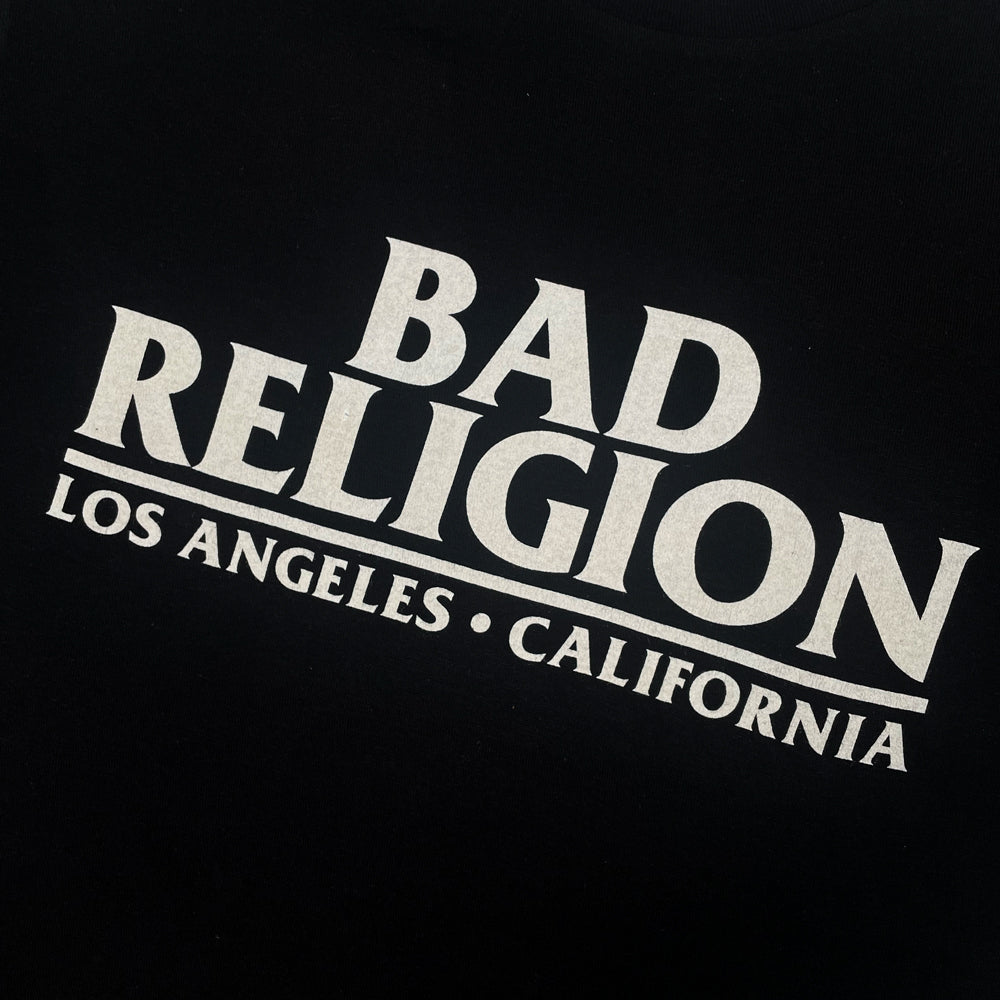Close up of the front print of black Bad Religion t-shirt with white typography reading "Bad Religion Los Angeles California"