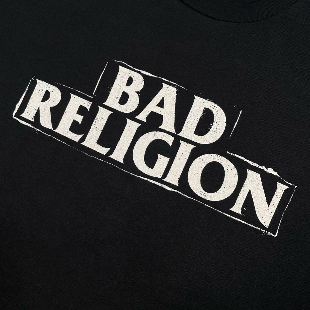 Close up of a black Bad Religion frontprint for graphic tee with typography reading "BAD RELIGION"