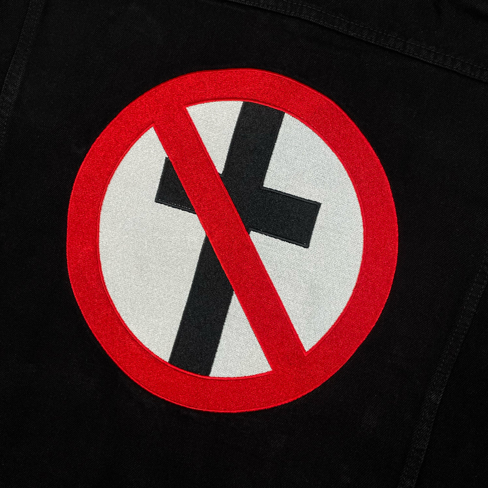 Close up of the back side of a black jacket with Bad Religion crossbuster logo
