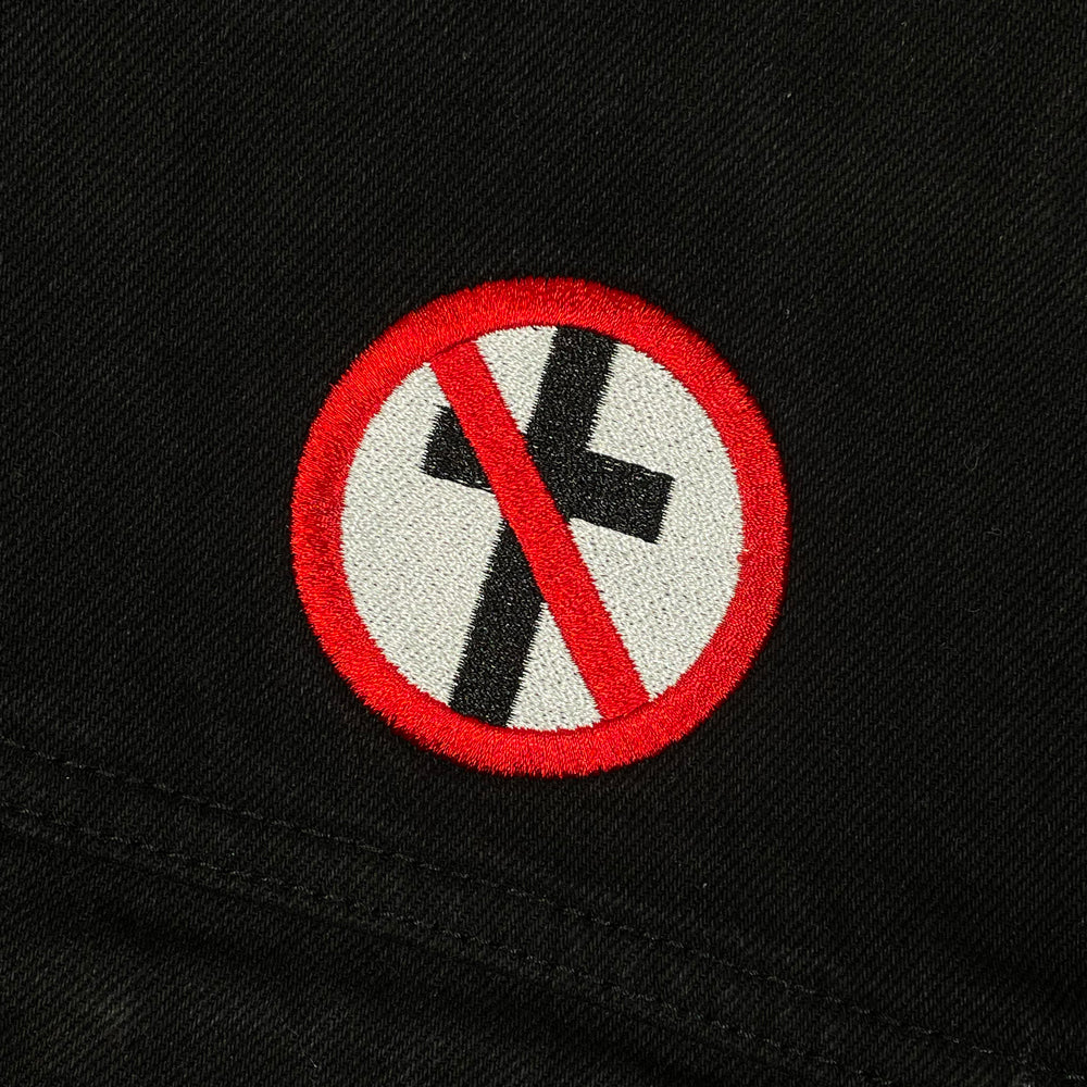 Close up of the front side of a black jacket with Bad Religion crossbuster logo