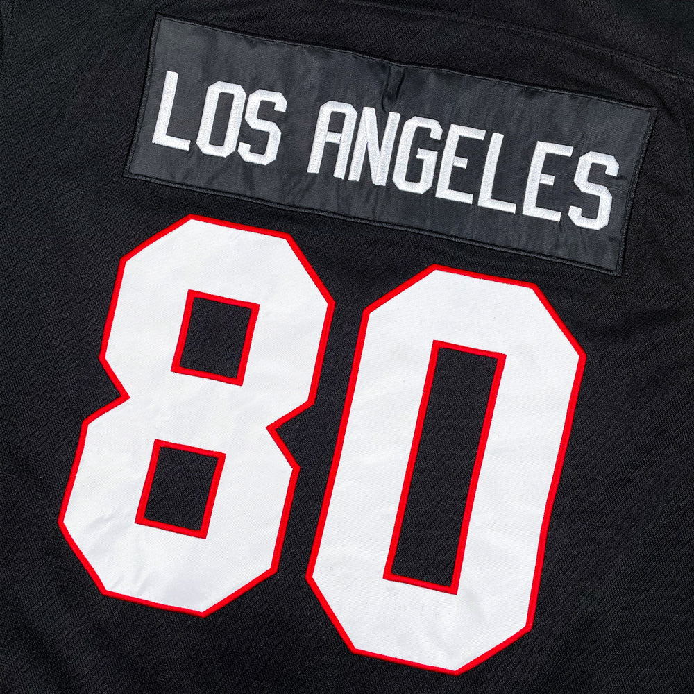 Close up of a black and red hockey jersey featuring the jersey number "80" and text reading "Los Angeles"