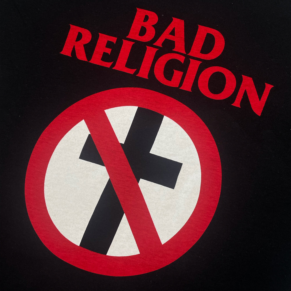 Close up of a black Bad Religion t-shirt front print with corssbuster logo and text reading "Bad Religion"