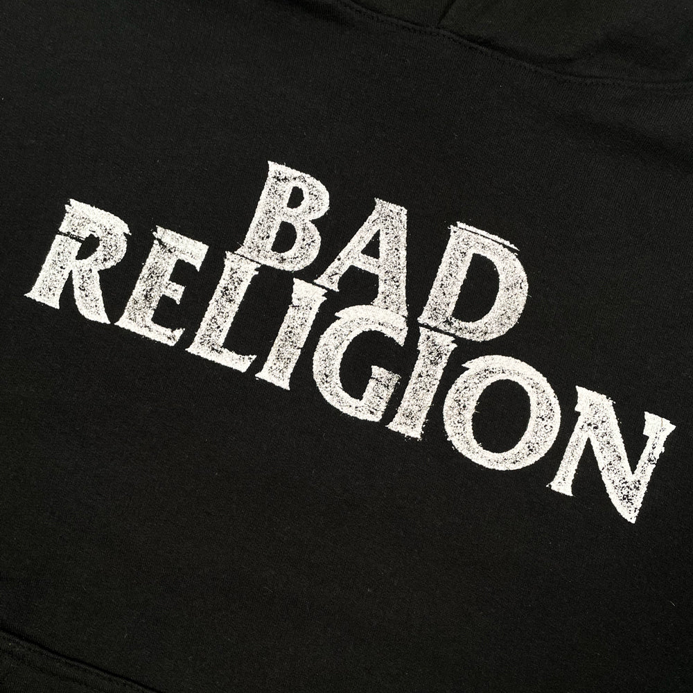 Close up of a front print of black Bad Religion hoodie with typography reading "Bad Religion"