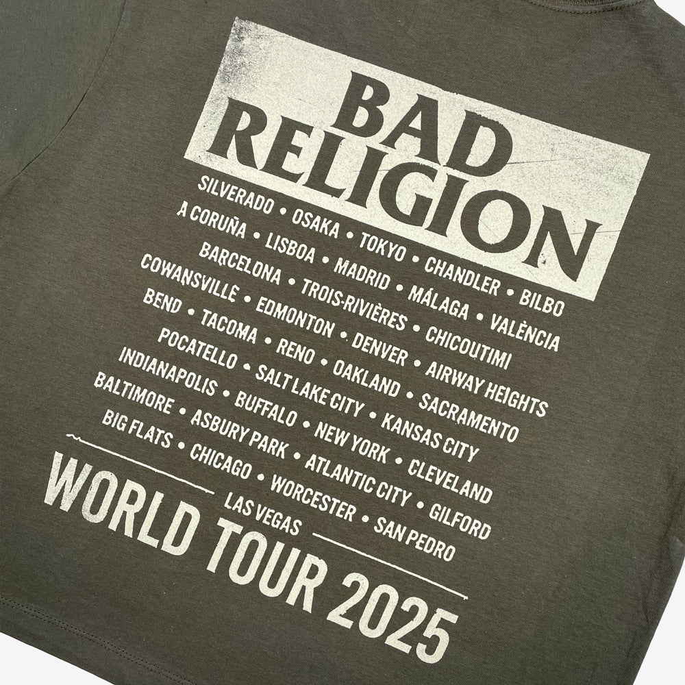 Close up of a green t-shirt with cream text reading "BAD RELIGION WORLD TOUR 2025" along with list of cities from the 2025 tour