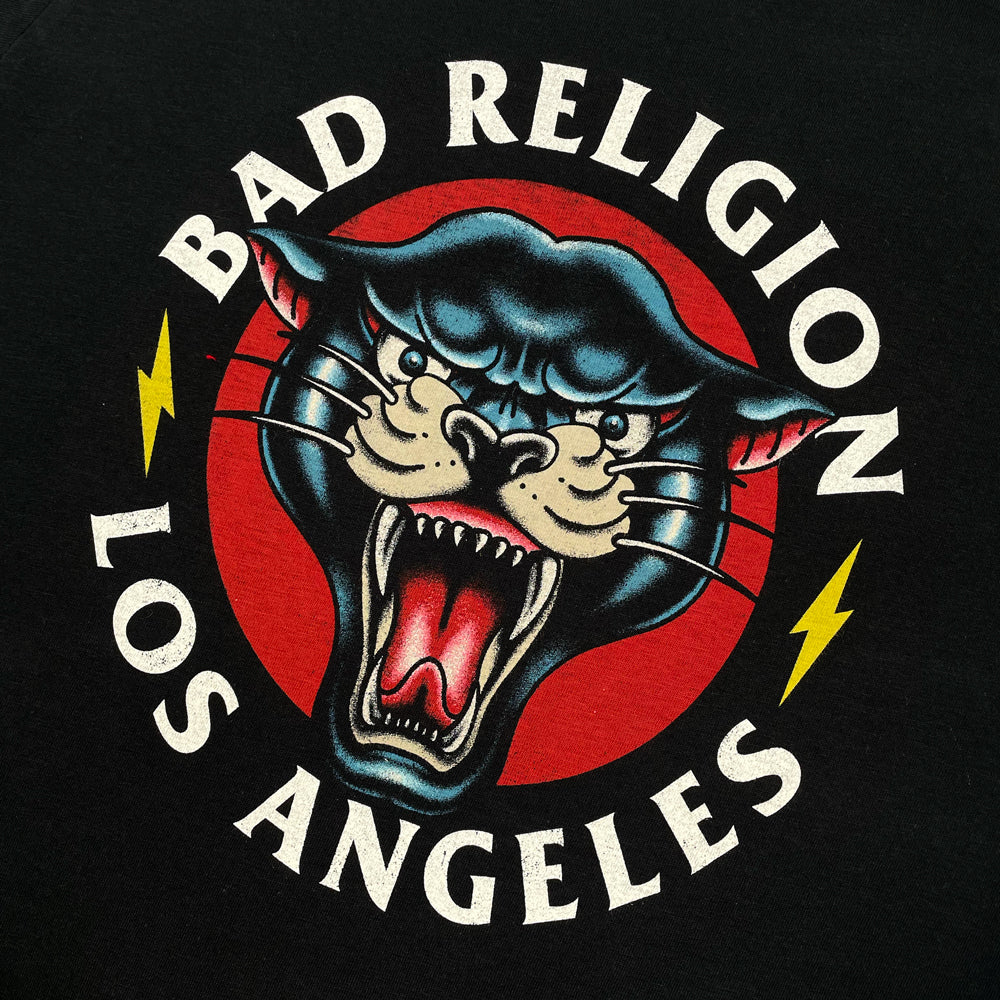 A close up of a black women's cut Bad Religion Tee with cougar graphic and lettering which reads "BAD RELIGION LOS ANGELES"