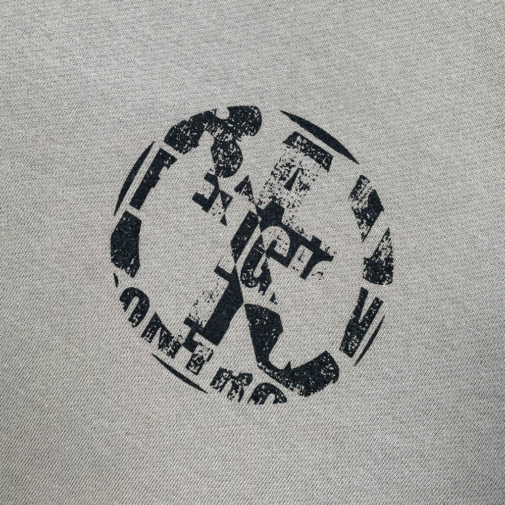 Close up of a cement grey Bad Religion sweatshirt from the front with iconic "crossbuster" logo