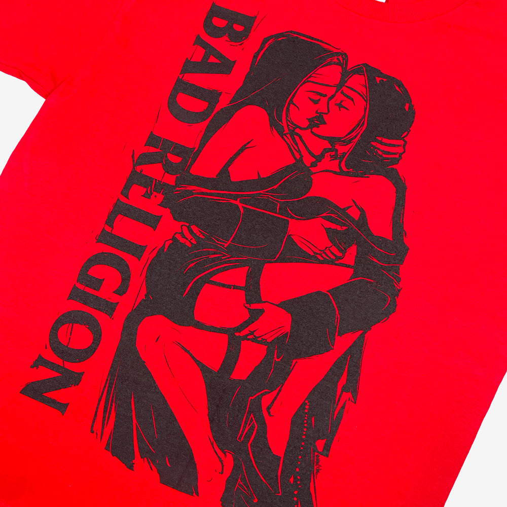 Close up of a red Bad Religion t-shirt with nun graphic next to black text that reads "BAD RELIGION"