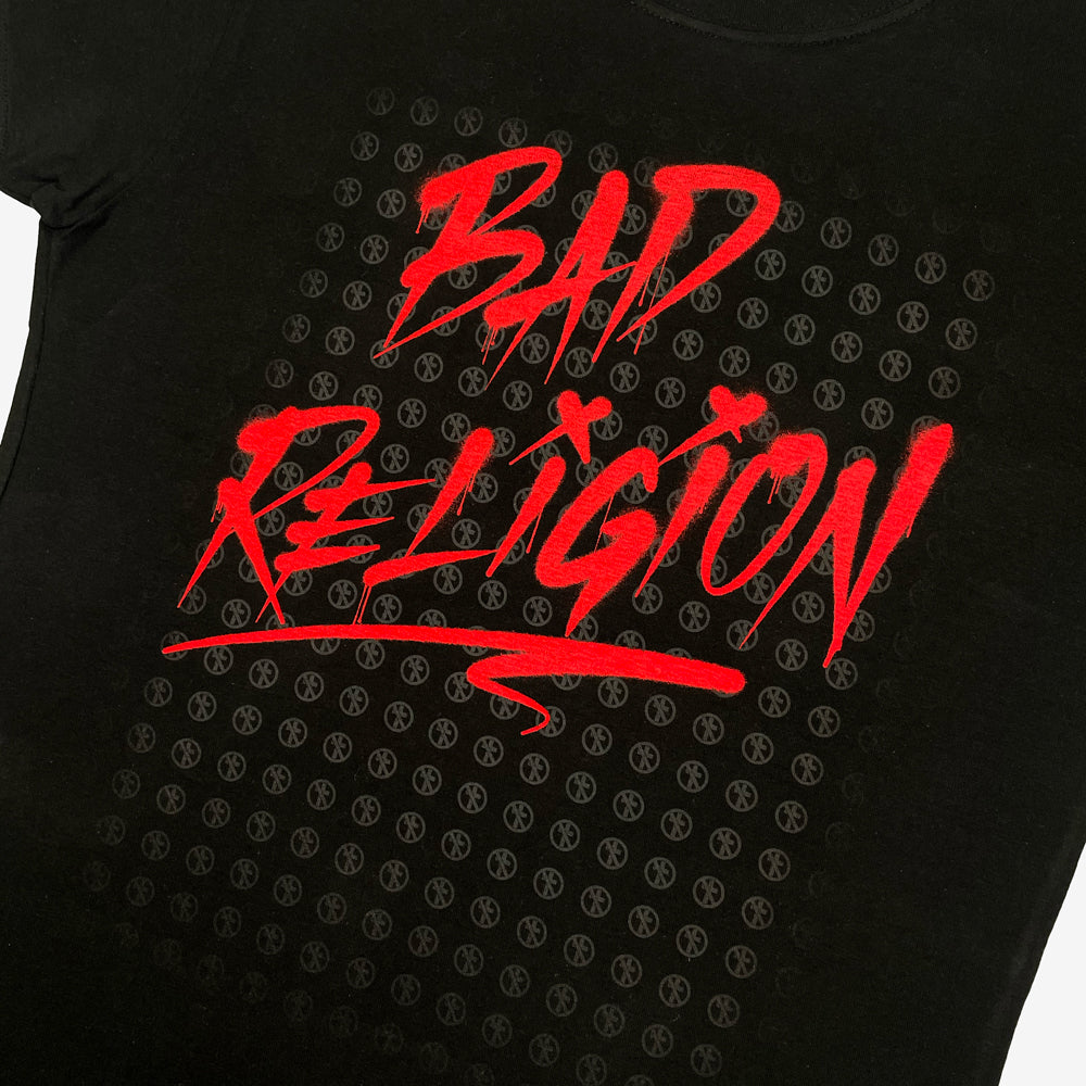 Close up of a black Bad Religion tee front print with typography reading "Bad Religion" in front of small crossbuster logos
