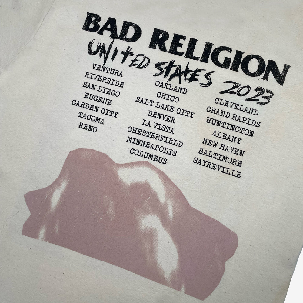 Close up of the back print of natural Bad Religion t-shirt with text reading "Bad Religion United States 2023" followed by a list of cities from the 2023 tour