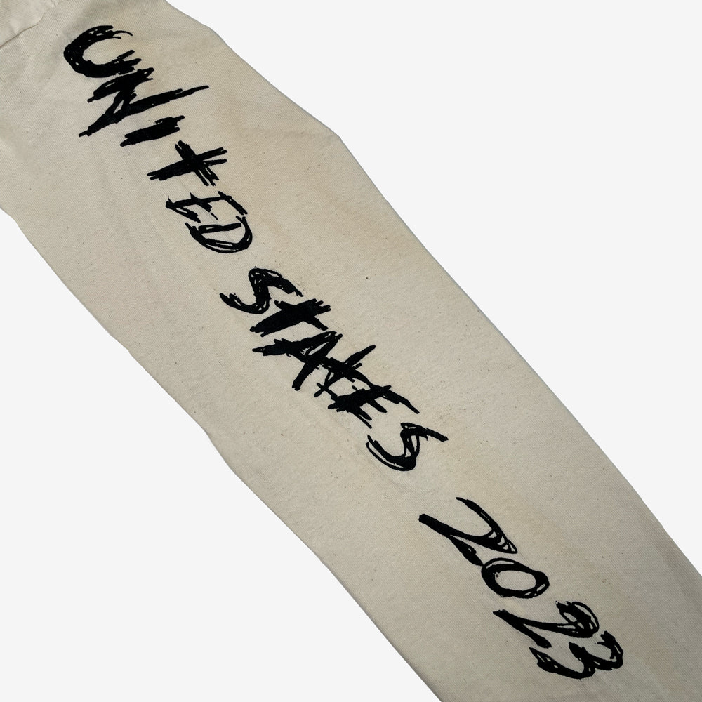 A natural color sleeve printed with 'UNITED STATES 2023' in a bold black brush-style font, shown diagonally on a plain white background.
