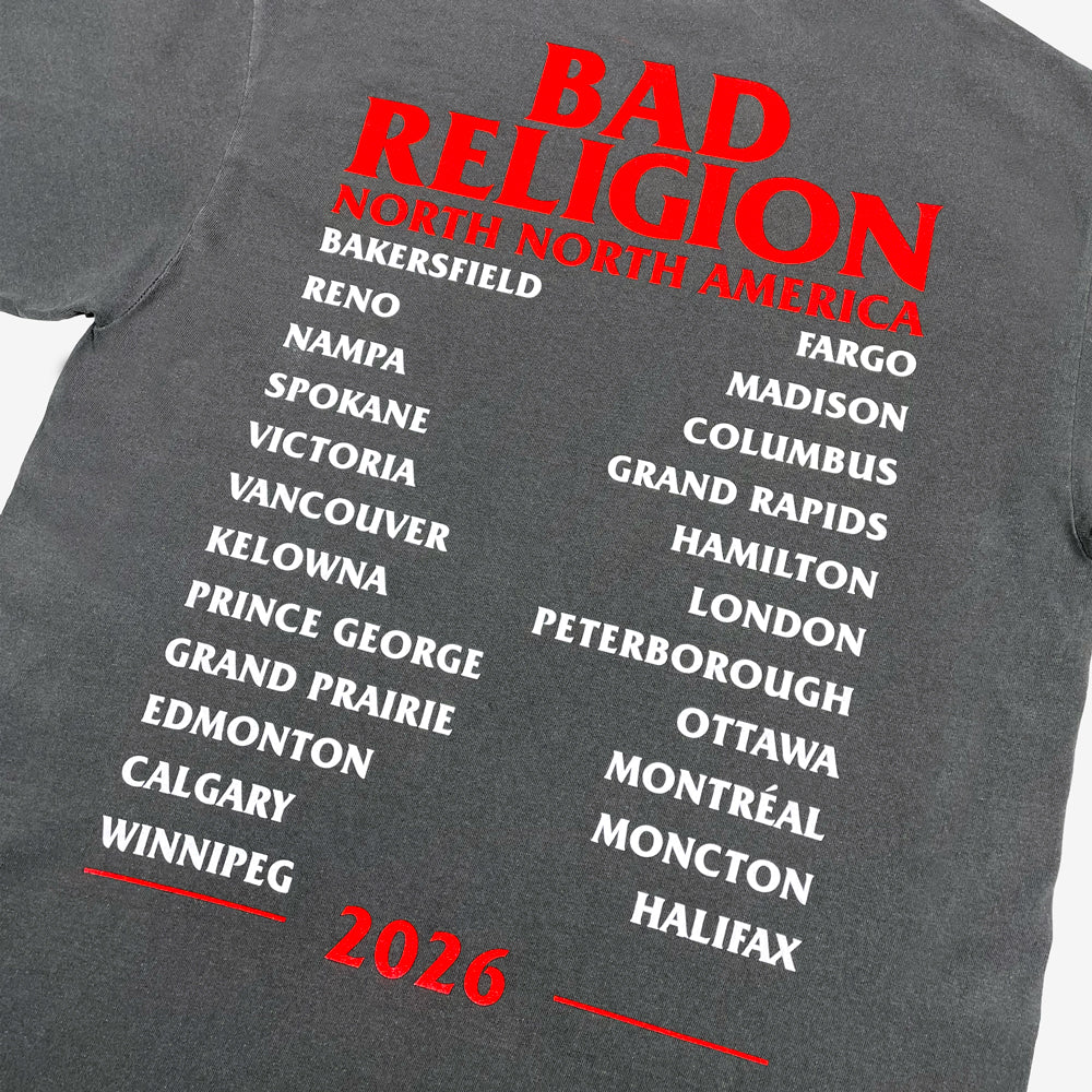 Close up of a faded black Bad Religion Classic Buster Tee with red band lettering, white tour cities, and red 2026 text.