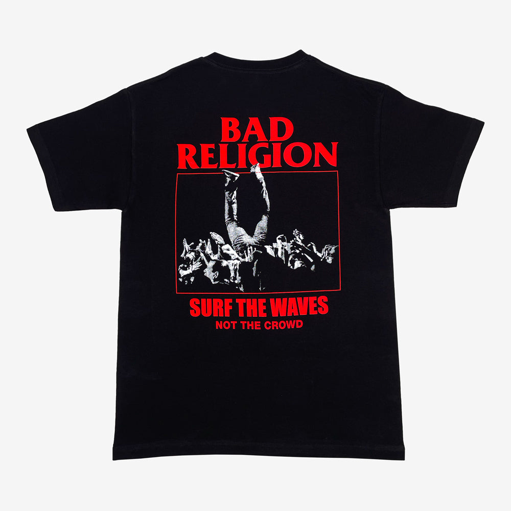 The back of a  black t shirt against a white background with red text reading "Bad Religion, Surf the Waves, Not the Crowd" and a black and white image of a person crowd surfing.