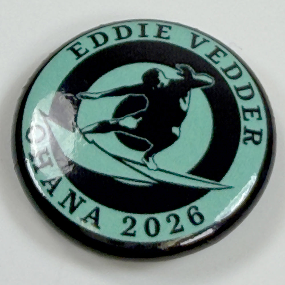 Close-up of Eddie Vedder Surf Association Button showing glossy finish, vintage surfer design, and Ohana 2026 details.