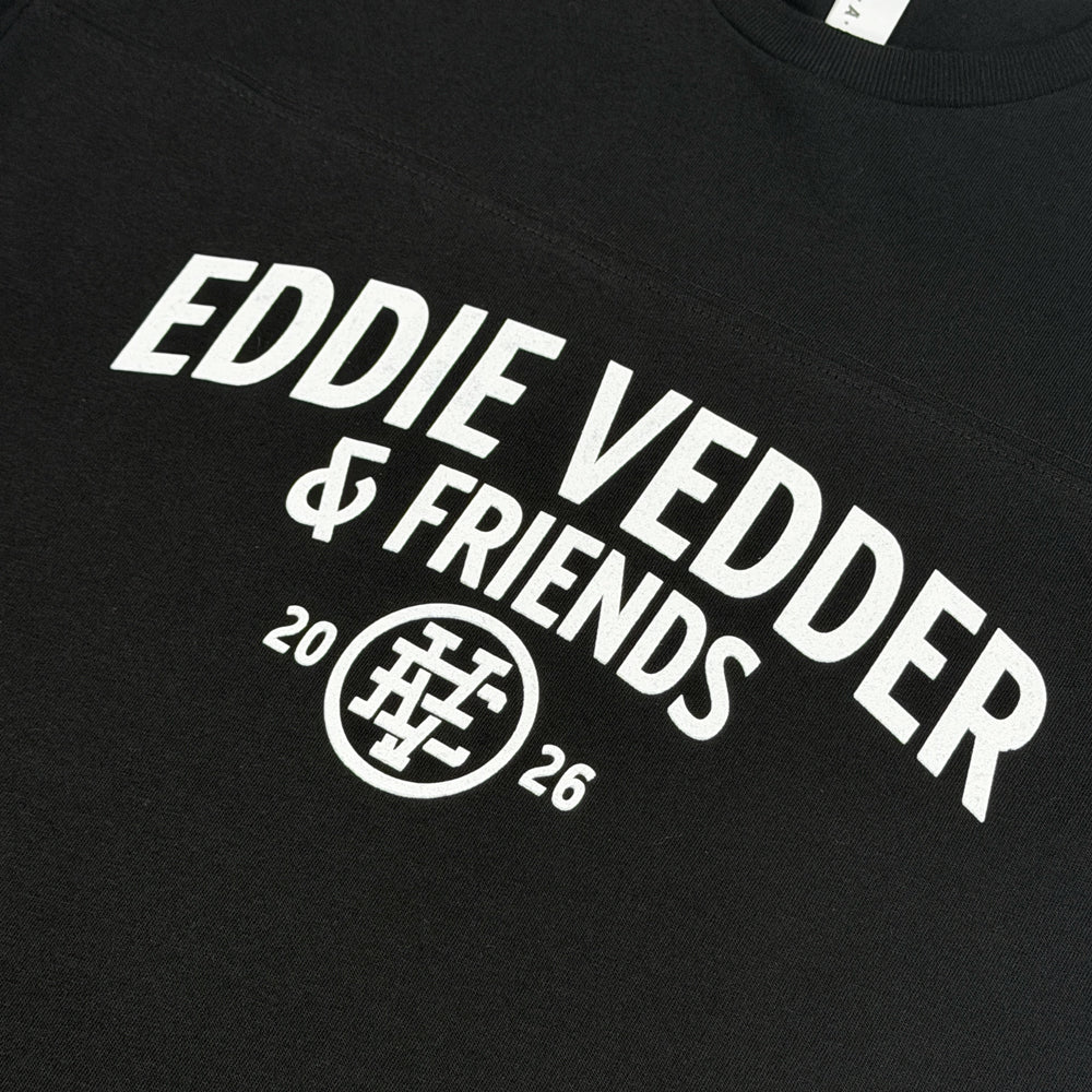 Close-up of white Eddie Vedder & Friends chest graphic on black Dana Point Football Tee