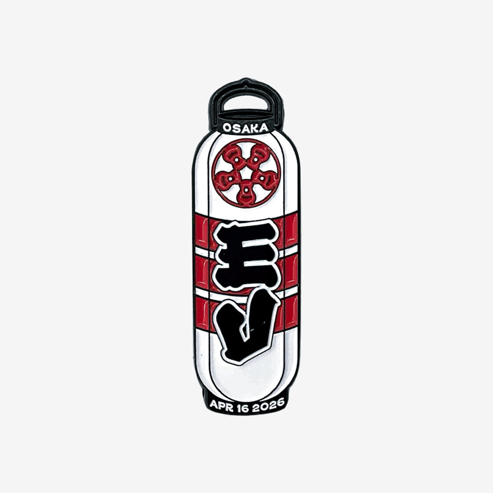 An enamel pin against a white background that is a design of a white and red Japanese decorative lantern. In white text at the top it reads "Osaka" and at the bottom it reads in white text "Apr 16 2026"