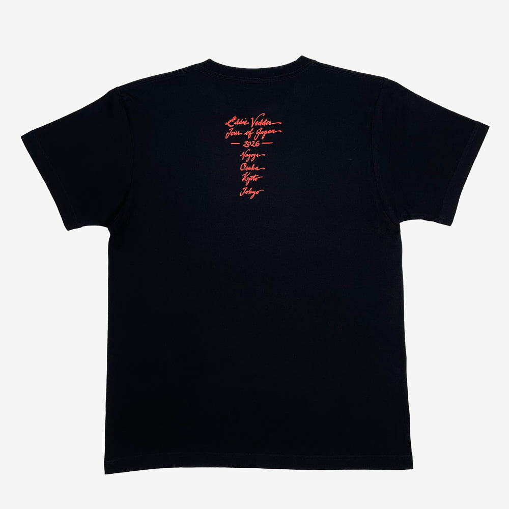 The back of a black T shirt against a white background with red text reading "Eddie Vedder, Tour of Japan, 2026, Nagoya, Osaka, Kyoto, Tokyo"
