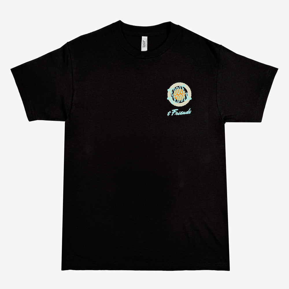 Black Eddie Vedder & Friends Mod Sun tee with a small front chest logo and retro sun and ocean artwork on the back in turquoise, orange, and cream.