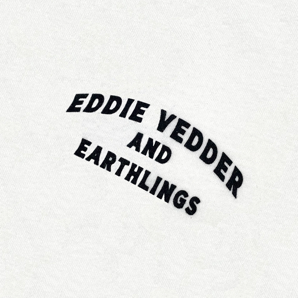 Close up of a white Tee with black text on the chest reading "Eddie Vedder and Earthling"