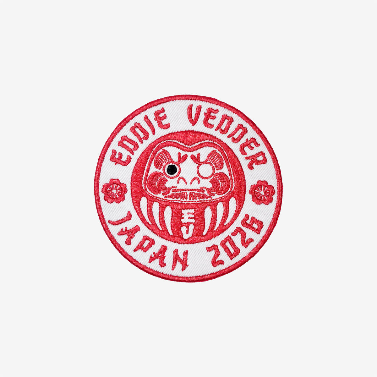 Red and white circular patch with 'Eddie Vedder Japan 2026' text and a daruma doll design on a white background.