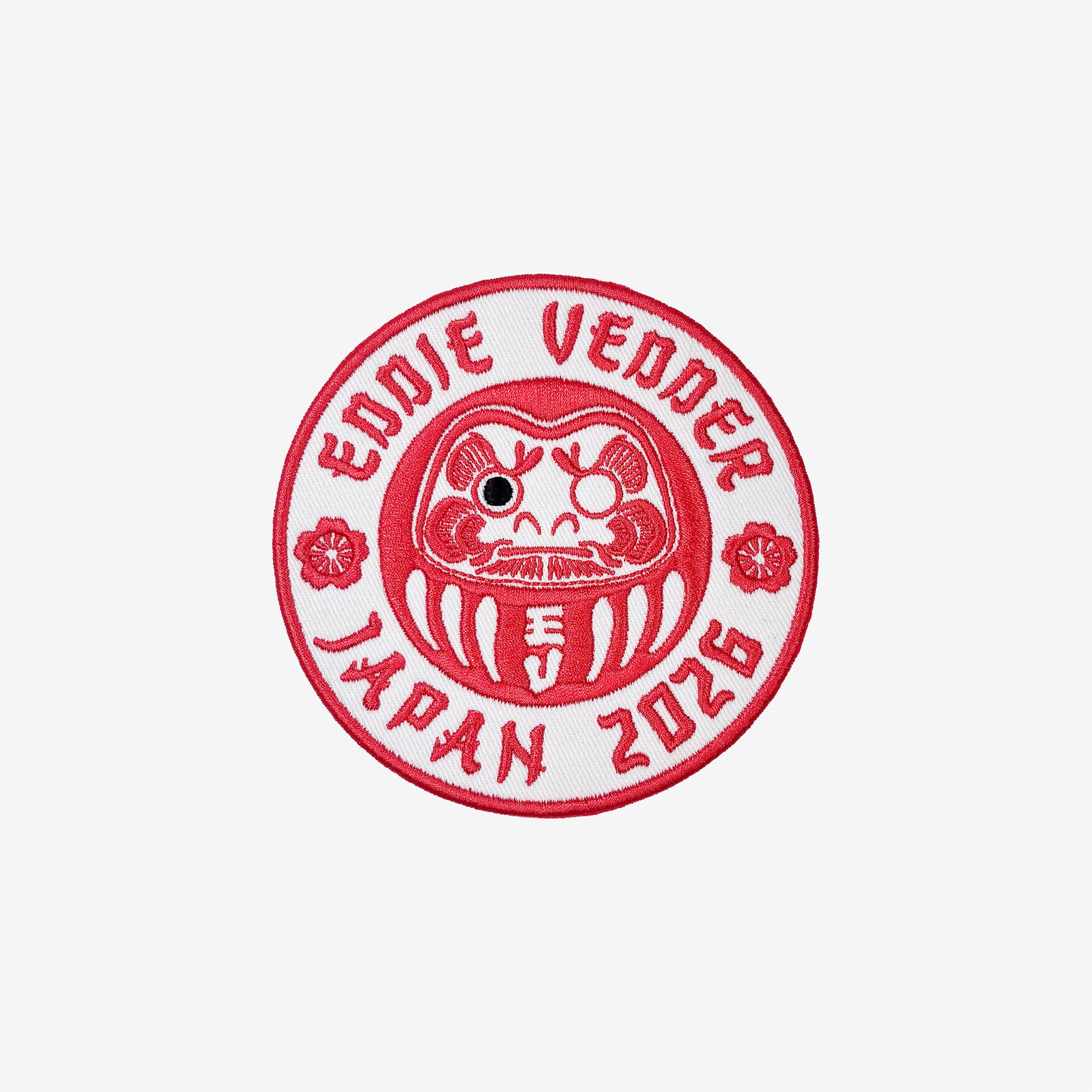 Red and white circular patch with 'Eddie Vedder Japan 2026' text and a daruma doll design on a white background.