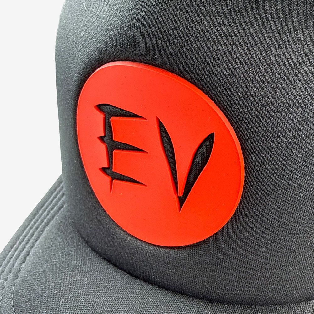 Black trucker cap with a red circular logo featuring the letters "EV" on a white background