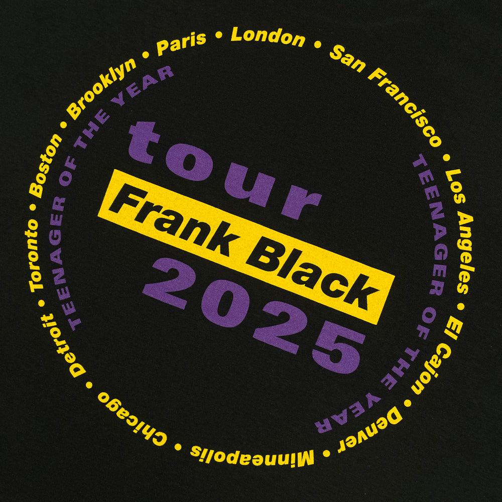 Close up of a black Frank Black t-shirt with text reading "tour FRANK BLACK 2025" and a list of cities from the 2025 tour