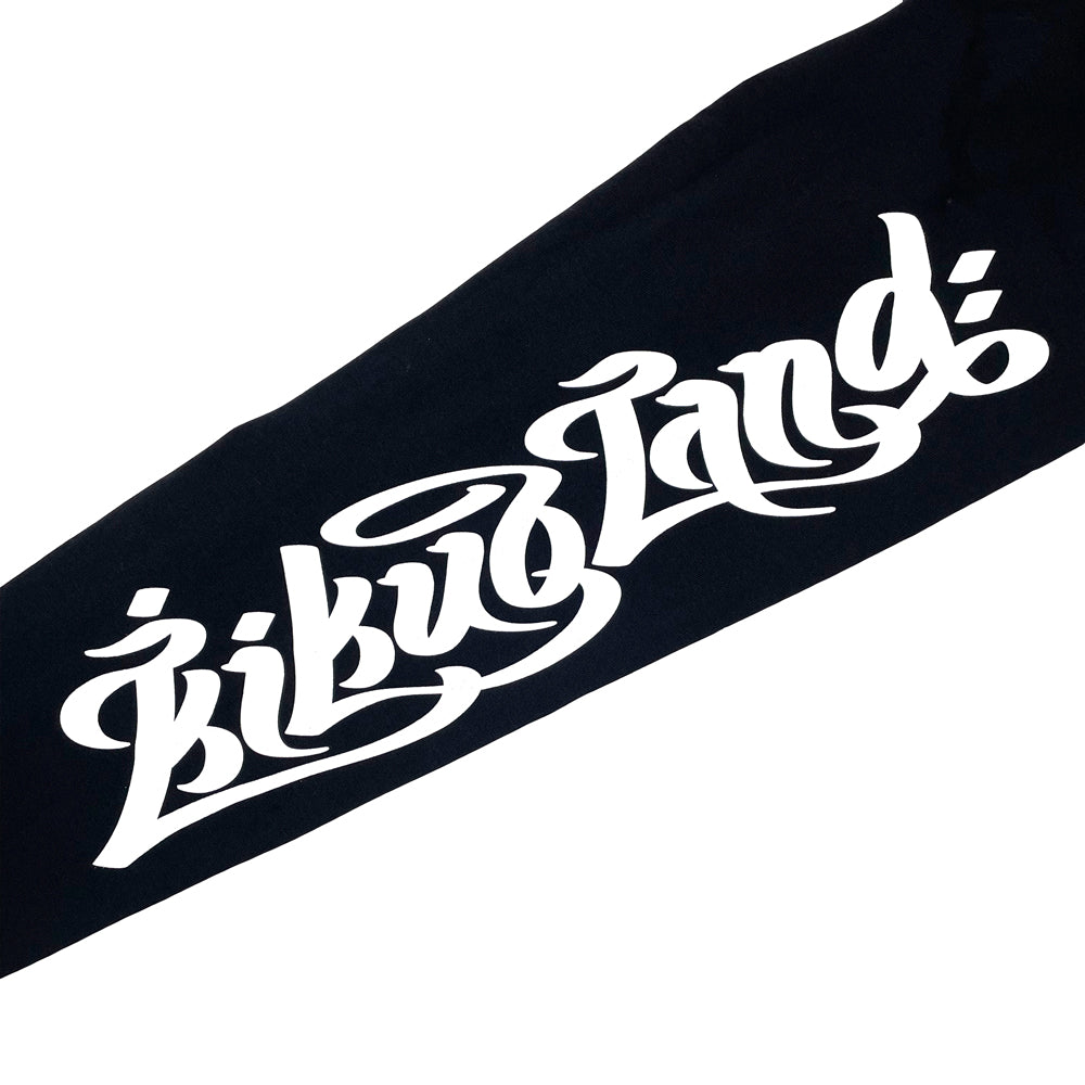 A close up of a black long sleeve sleeve with decorative white text reading "Kikuoland"