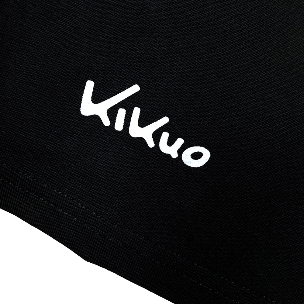 Close up of a black shirt sleeve with white text reading "Kikuo"