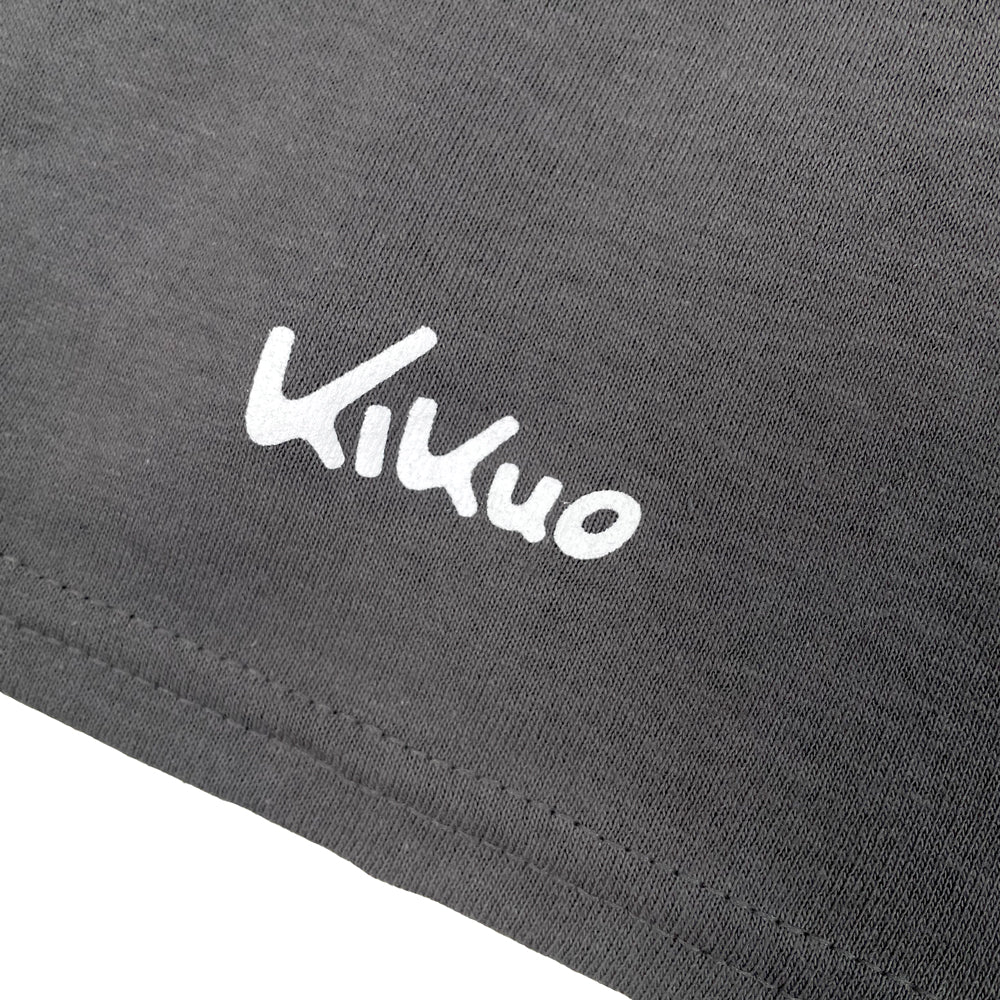 Close up of a gray shirt sleeve with white text reading "Kikuo"