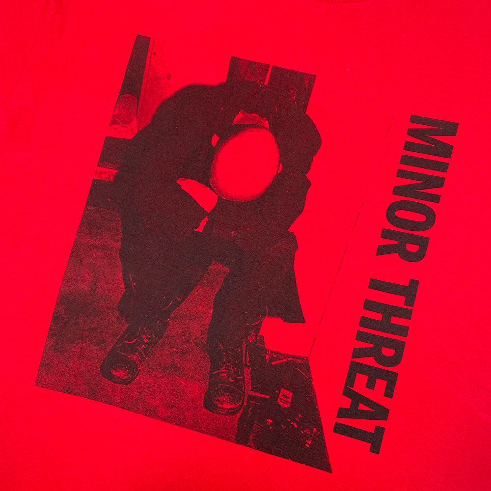 Close up of a red Minor Threat tee with graphic of the LP Album cover