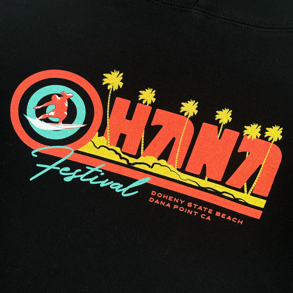 Close up of a black sweatshirt with graphic script which reads "OHANA FESTIVAL DOHENY STATE BEACH DANA POINT CA"