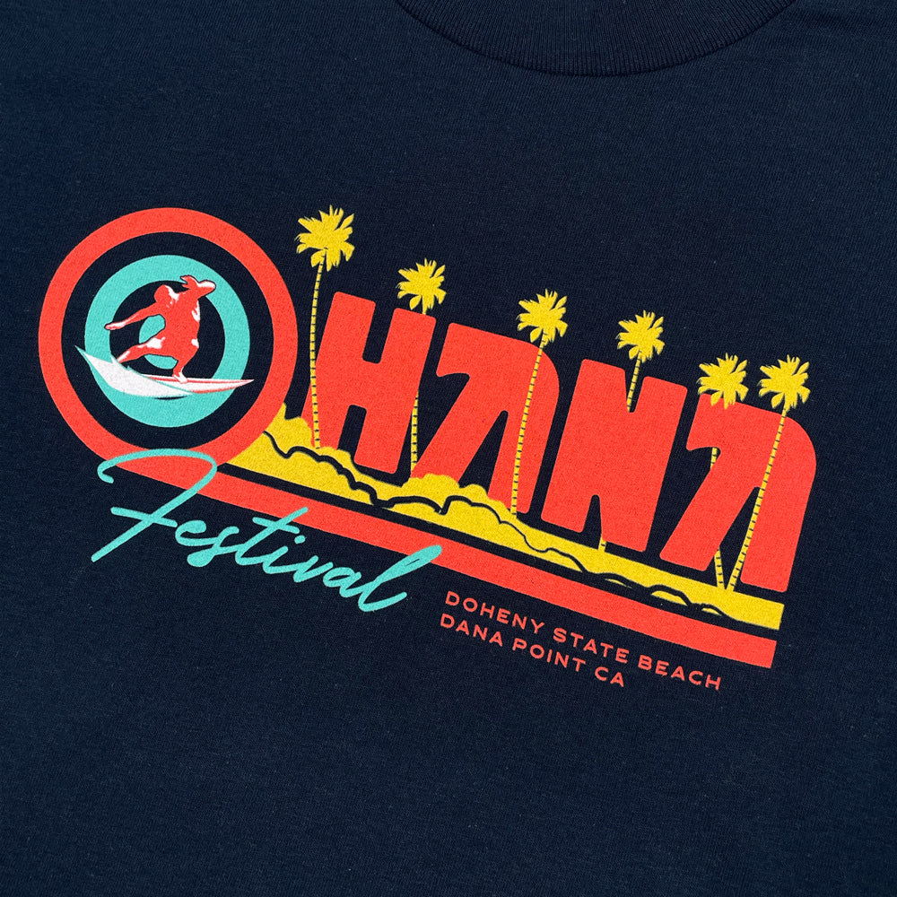 Close up of a navy t-shirt from the front with graphic script reading "Ohana Festival Doheny State Beach Dana Point CA" 