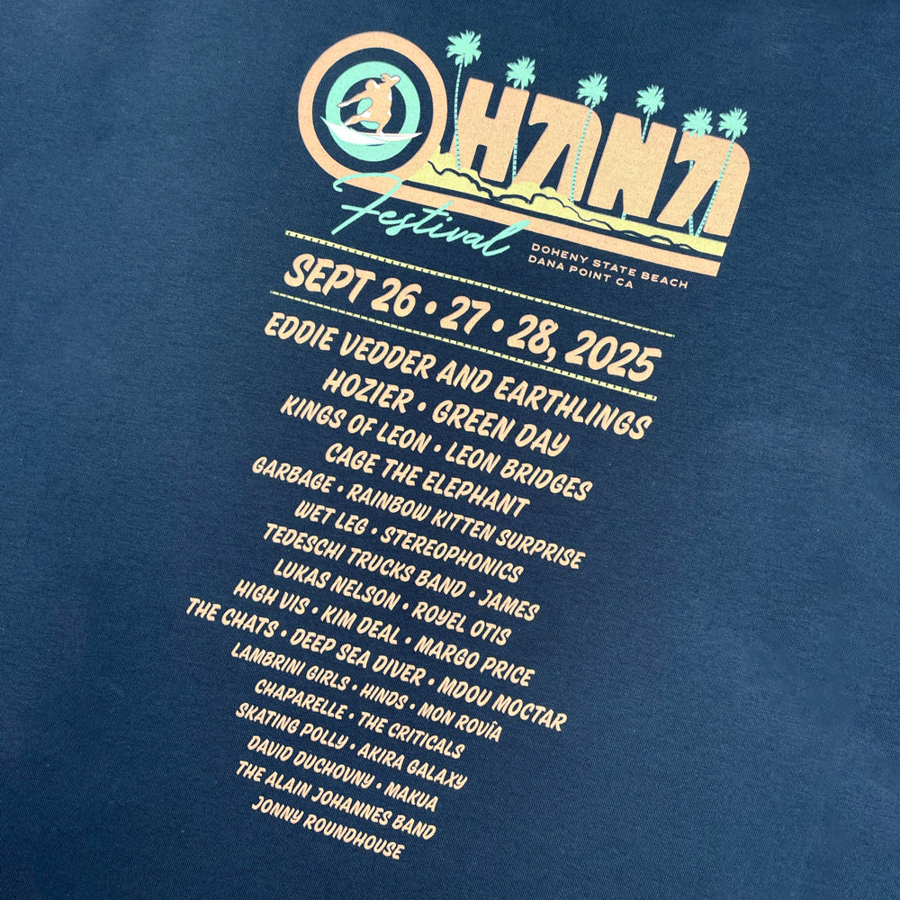 Close up of a navy Ohana Festival t-shirt with list of bands from the 2025 festival and graphic lettering which reads "Ohana Festival Doheny State Beach Dana Point CA Sept 26, 27, 28, 2025"