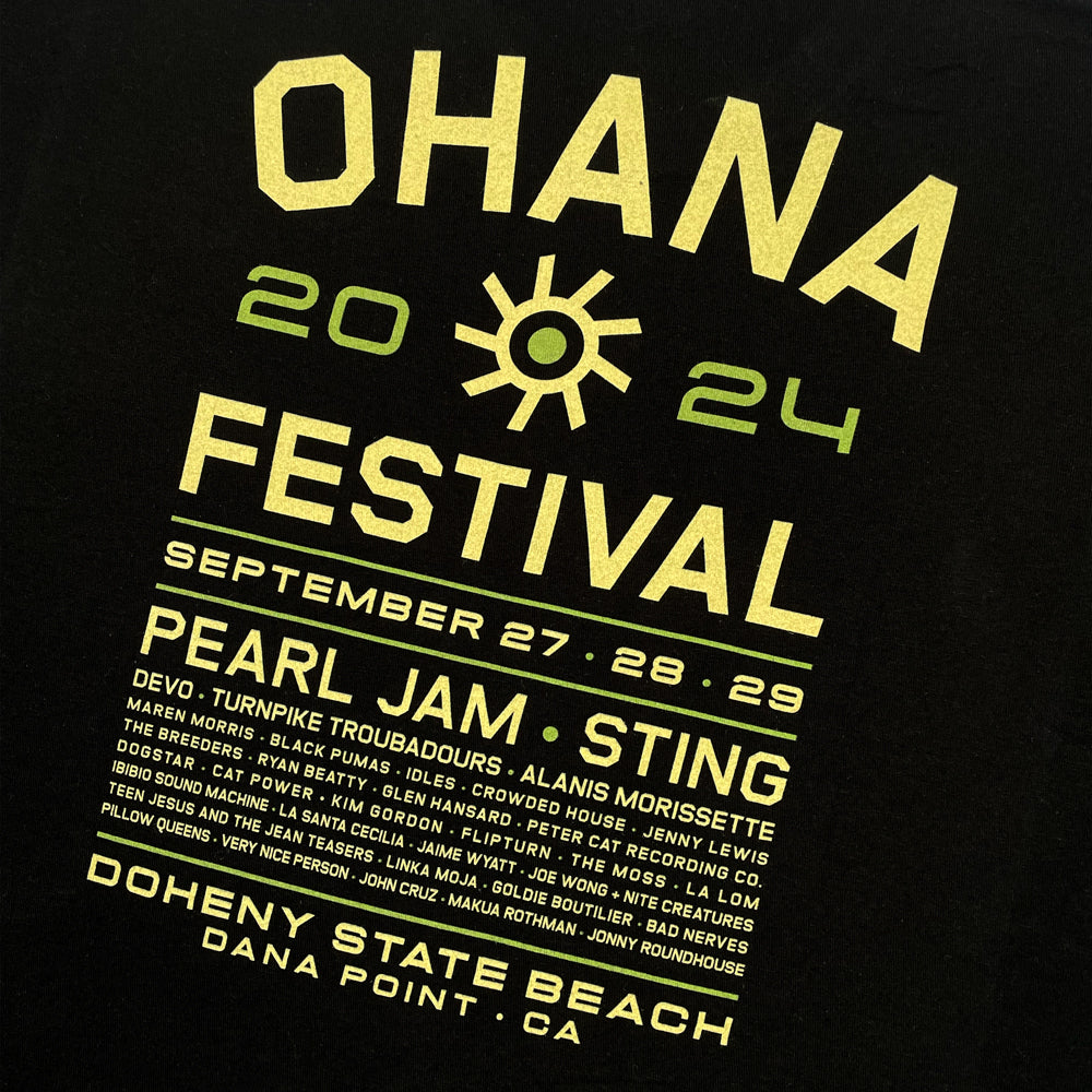 Close up of a black t-shirt with yellow text reading "OHANA FESTIVAL 2024; September 27 28 29 Doheny State Beach Dana Point CA" followed by the list of bands from the festival