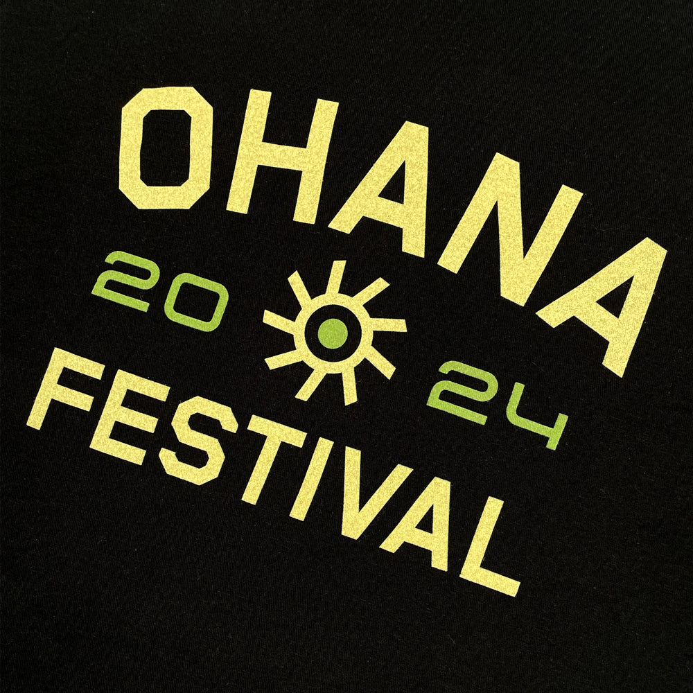 Close up of a black t-shirt front print with 'OHANA FESTIVAL 2024' printed in yellow text on the front.