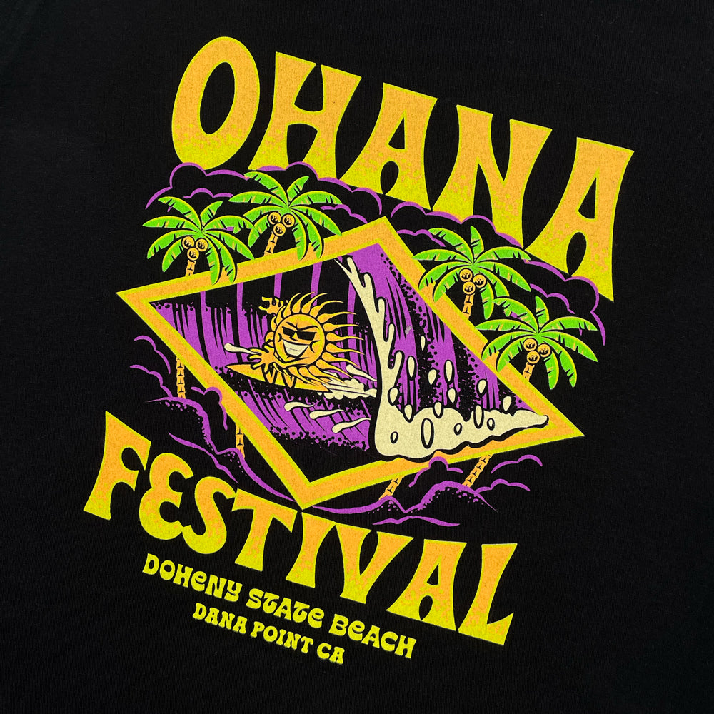 Close up of a black t-shirt front print with yellow text reading "Ohana Festival Doheny State Beach Dana Point CA" and a graphic of a surfing sun