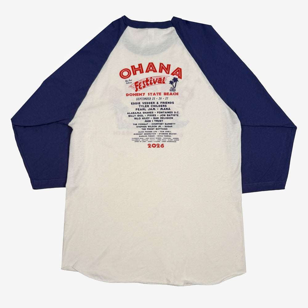 Back of the natural-and-blue Ohana Surf Meet Tee with red festival lettering and a blue artist lineup.