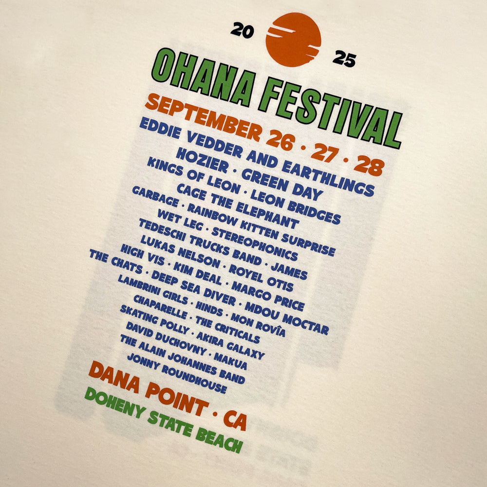 Close up of a cream Ohana Festival t-shirt from the back featuring list of bands playing at the 2025 festival and text reading "Ohana Festival; September 26, 27, 28; Dana Point, CA; Doheny State Beach