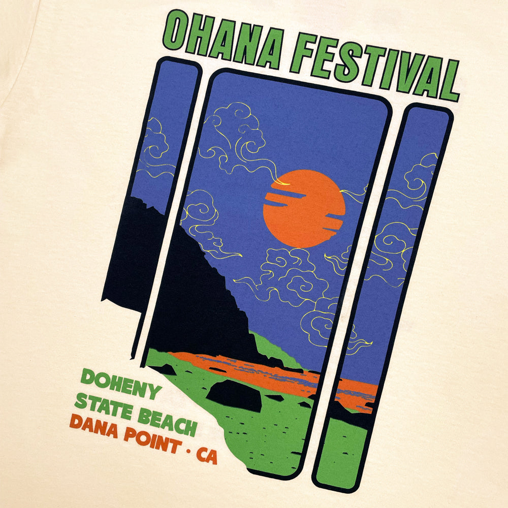 Close up of a cream Ohana Festival t-shirt from the front featuring graphic of sunset at the beach and the words "OHANA FESTIVAL DOHENY STATE BEACH DANA POINT, CA"