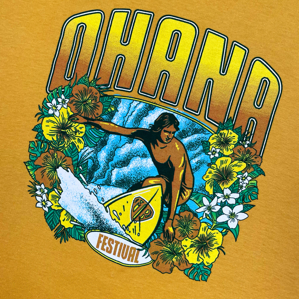 Close up of a yellow Ohana Festival t-shirt with graphic of a surfer and text reading "OHANA FESTIVAL"