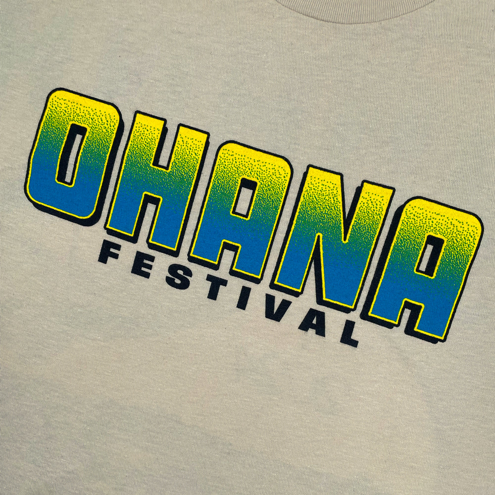 Close up of a beige Ohana Festival t-shirt front print  with text reading "Ohana Festival"