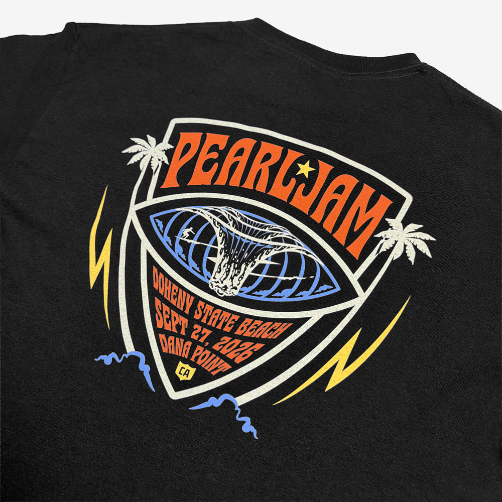 Close-up of Pearl Jam Big Kahuna surf graphic with palm trees and Dana Point event details on black tee