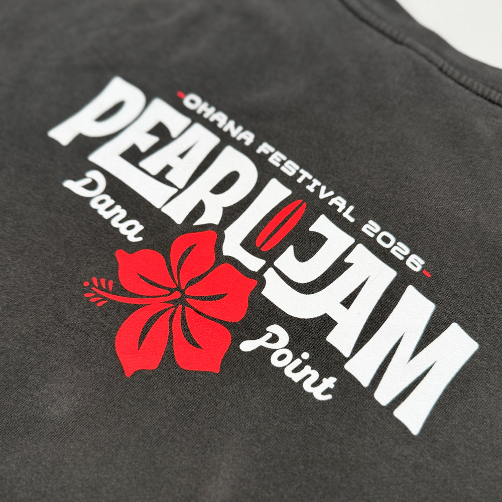 Close up of a dark gray washed crewneck sweatshirt shown from the back, featuring a graphic print with the text 'Ohana Festival 2026, PEARL JAM, Dana Point' and a red hibiscus flower on a white background.
