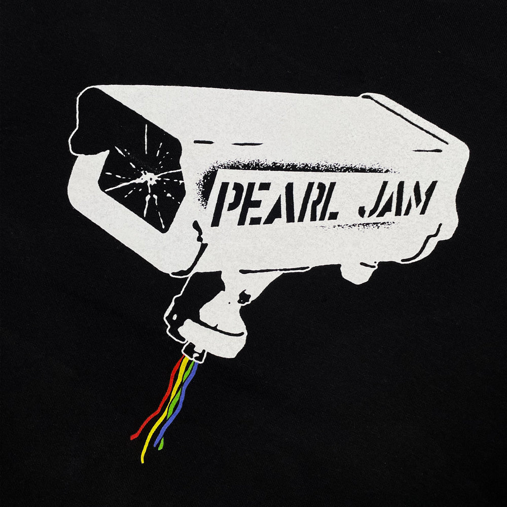 Close up of a black Pearl Jam t-shirt with graphic of a surveillance camera with text reading "Pearl Jam"
