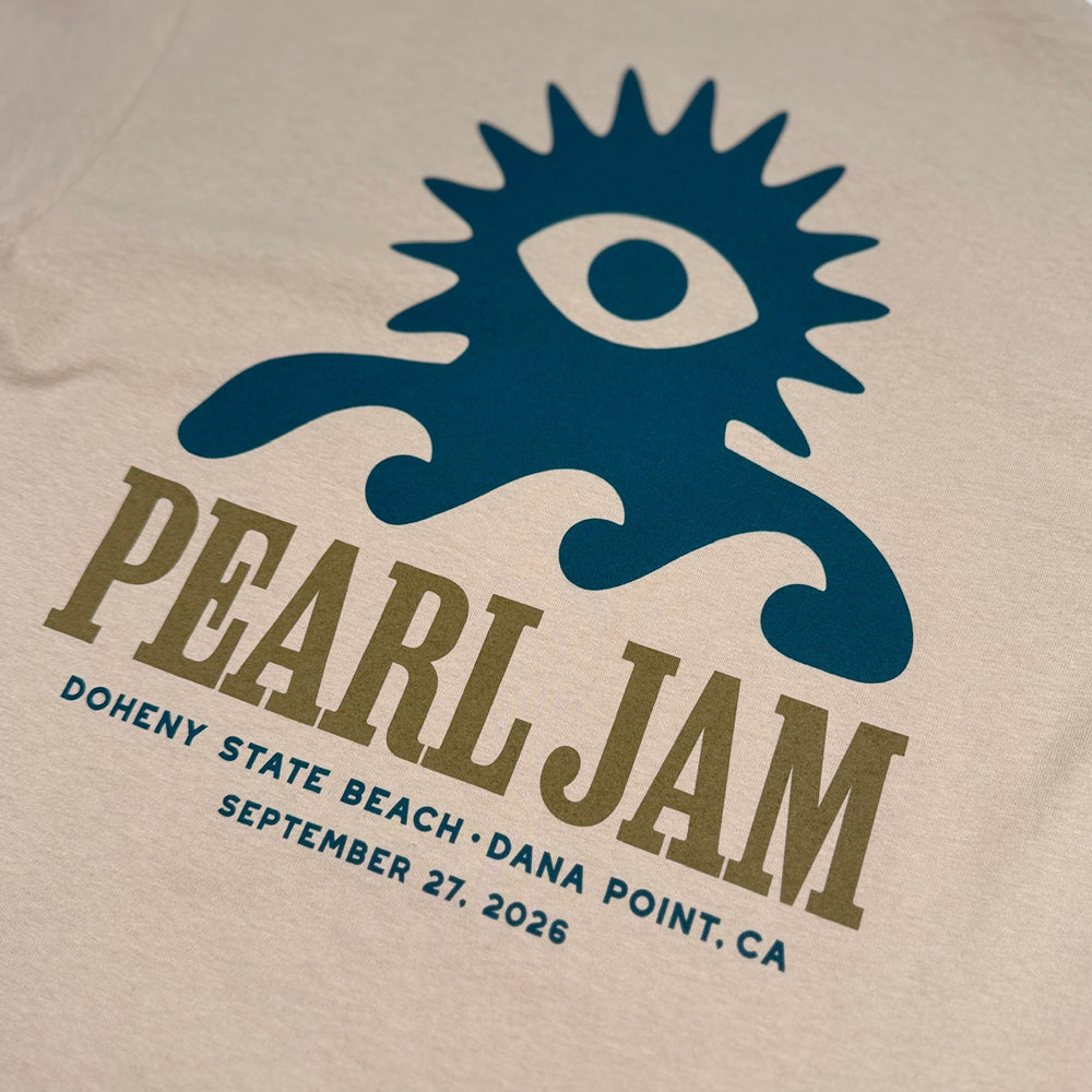Pearl Jam Wave Lord Tee in sand with large blue Wave Lord character and Pearl Jam Dana Point graphic