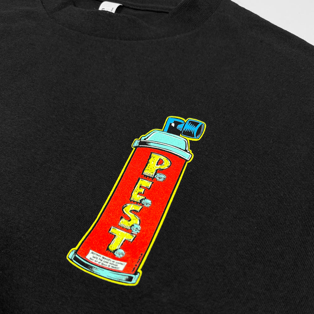 Close-up of red spray can with yellow P.E.S.T lettering and turquoise details on black tee